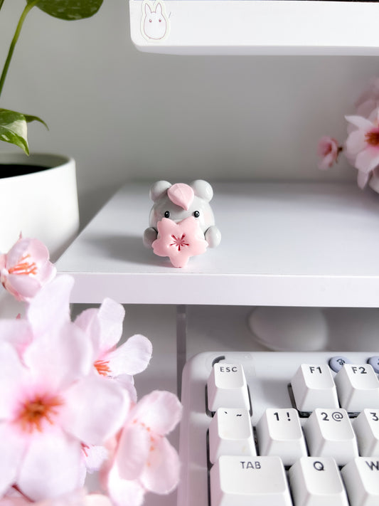 Totoro holding sakura bloom